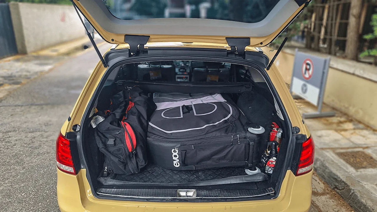 Mercedes wagon trunk packed with suitcases and an EVOC bike bag